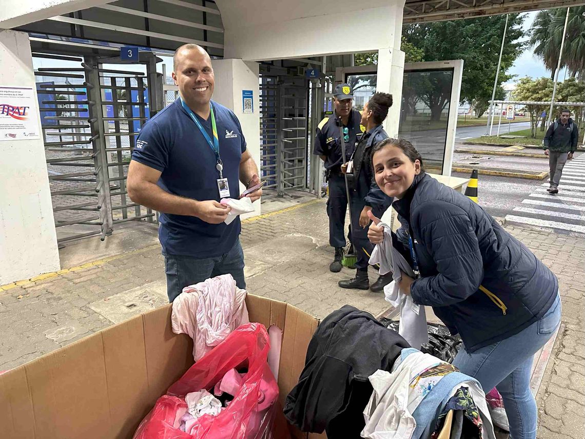 Two Michelin employees are sorting clothes they have collected.